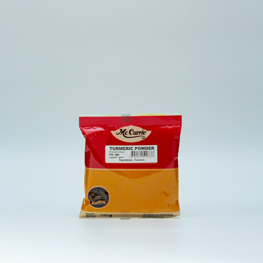 Bag of McCurry Turmeric Powder on a light gray background