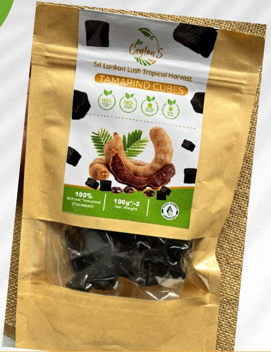 Packaged tamarind cubes with a gold and white label on a white background